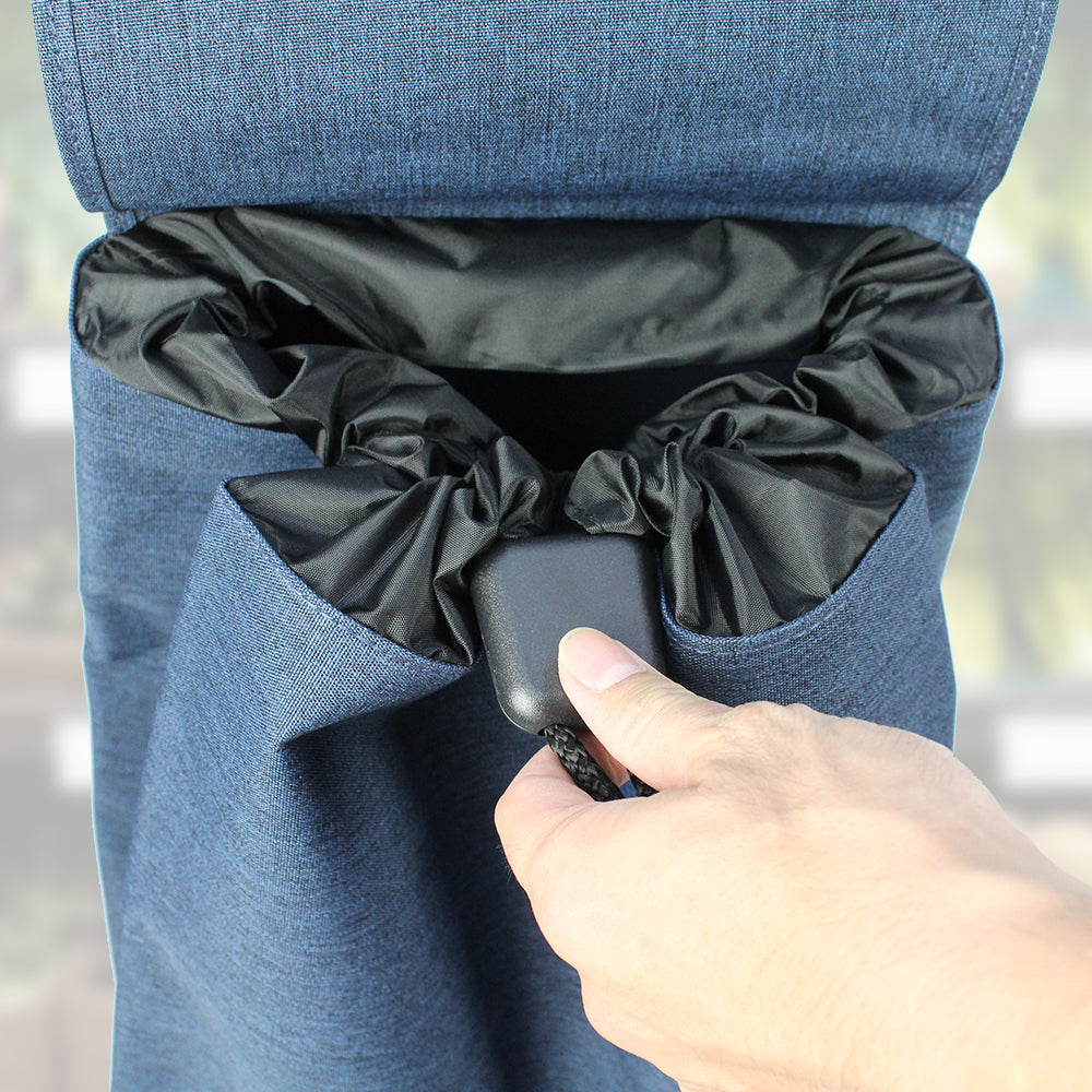 A blue Rolser Baby Joy Market & Shopping Trolley with an aluminum frame and a water-resistant polyester bag, with the drawstring mechanism being tightened.